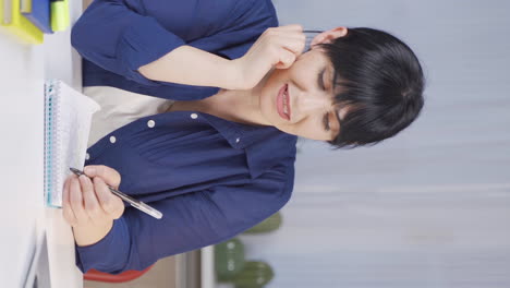 Vertical-video-of-Female-student-stressed-and-biting-her-nails.